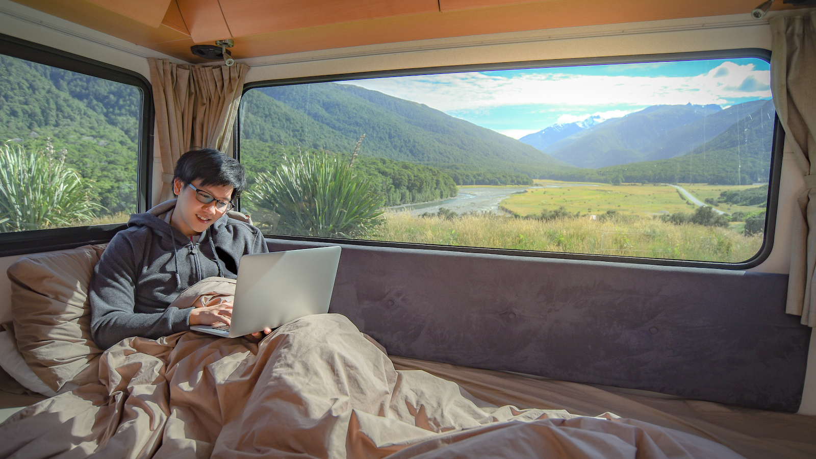 man on laptop in campervan
